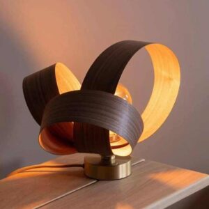 Illuminate your space with this exquisite handmade table lamp. Crafted from peeled veneer, its unique design exudes warmth and sophistication, making it a captivating addition to any room.
