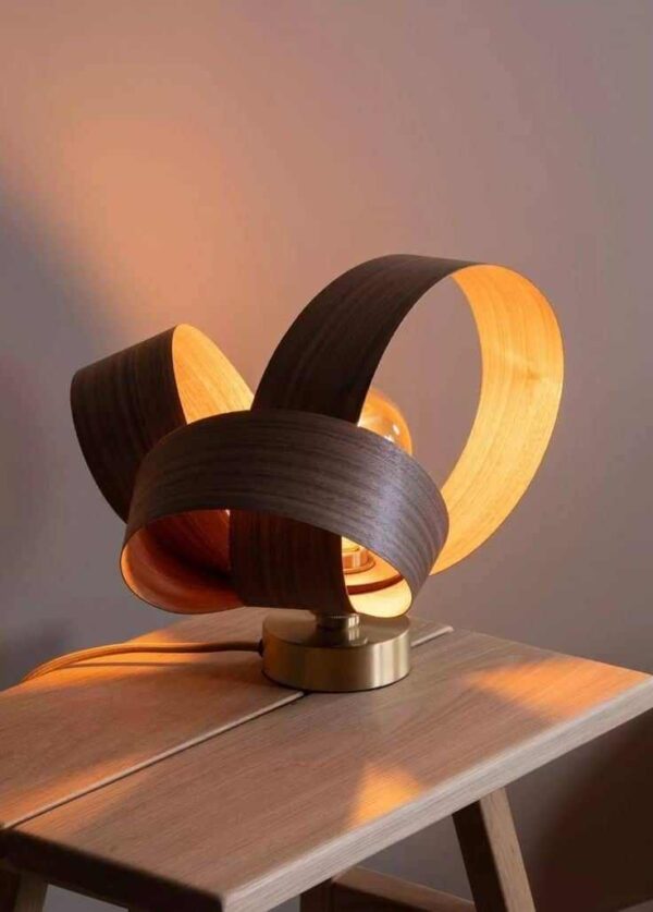 Illuminate your space with this exquisite handmade table lamp. Crafted from peeled veneer, its unique design exudes warmth and sophistication, making it a captivating addition to any room.